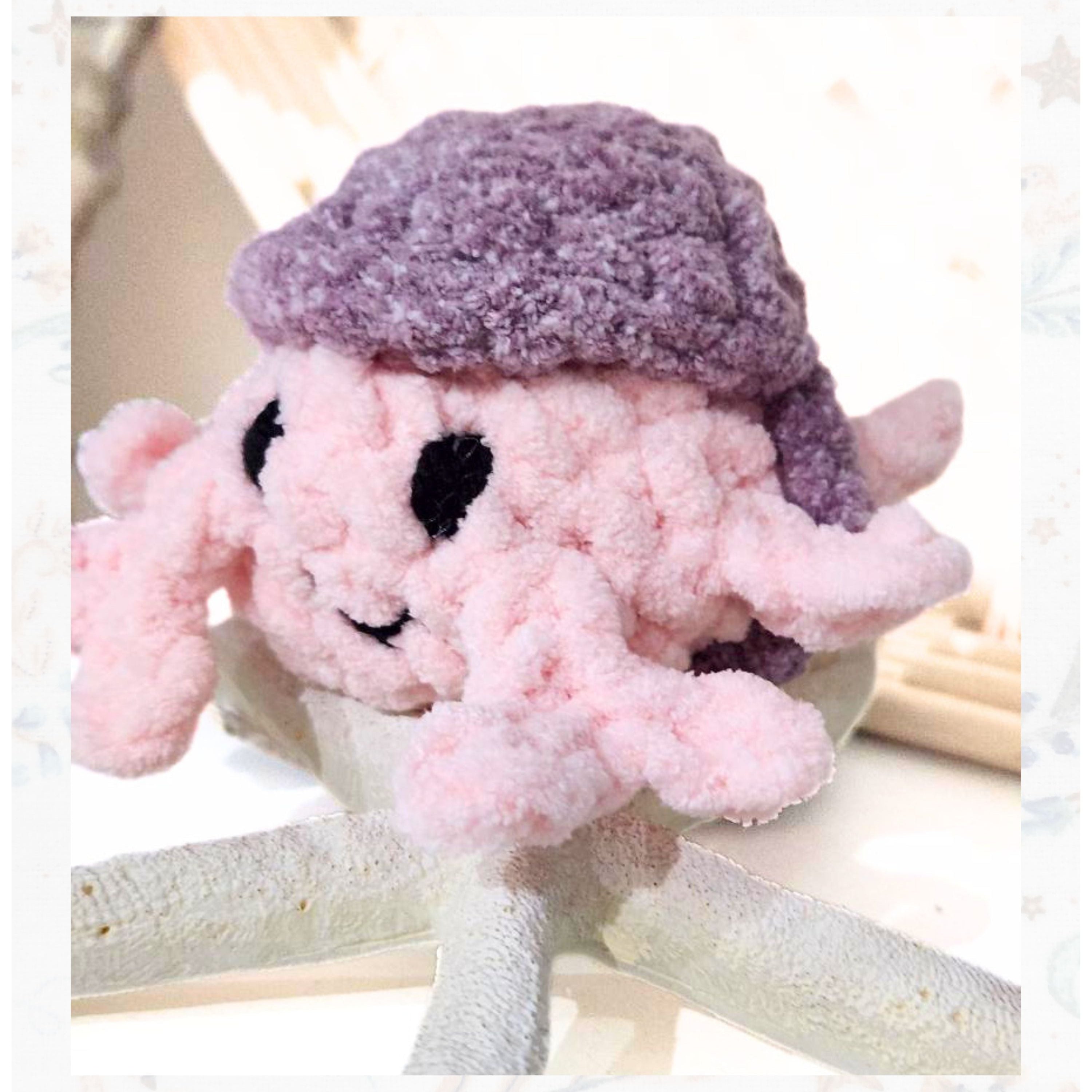 Profile view of a pink Rainbow Rover pocket companion wearing a signature purple sun hat, ready for a playful seaside adventure handcrafted by Coastline Boutique