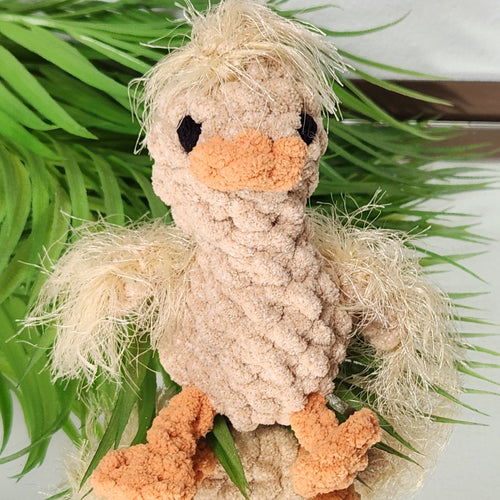 Handmade golden crochet gosling plushie named Nugget, featuring hand-embroidered eyes and a soft yarn texture, by Coastline Boutique