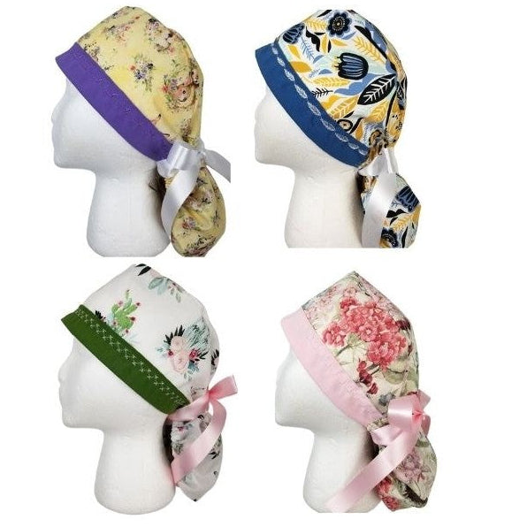 A collection of whimsical and seasonal ponytail surgical caps featuring bunnies, butterflies, cactus and harvest prints by Coastline Boutique