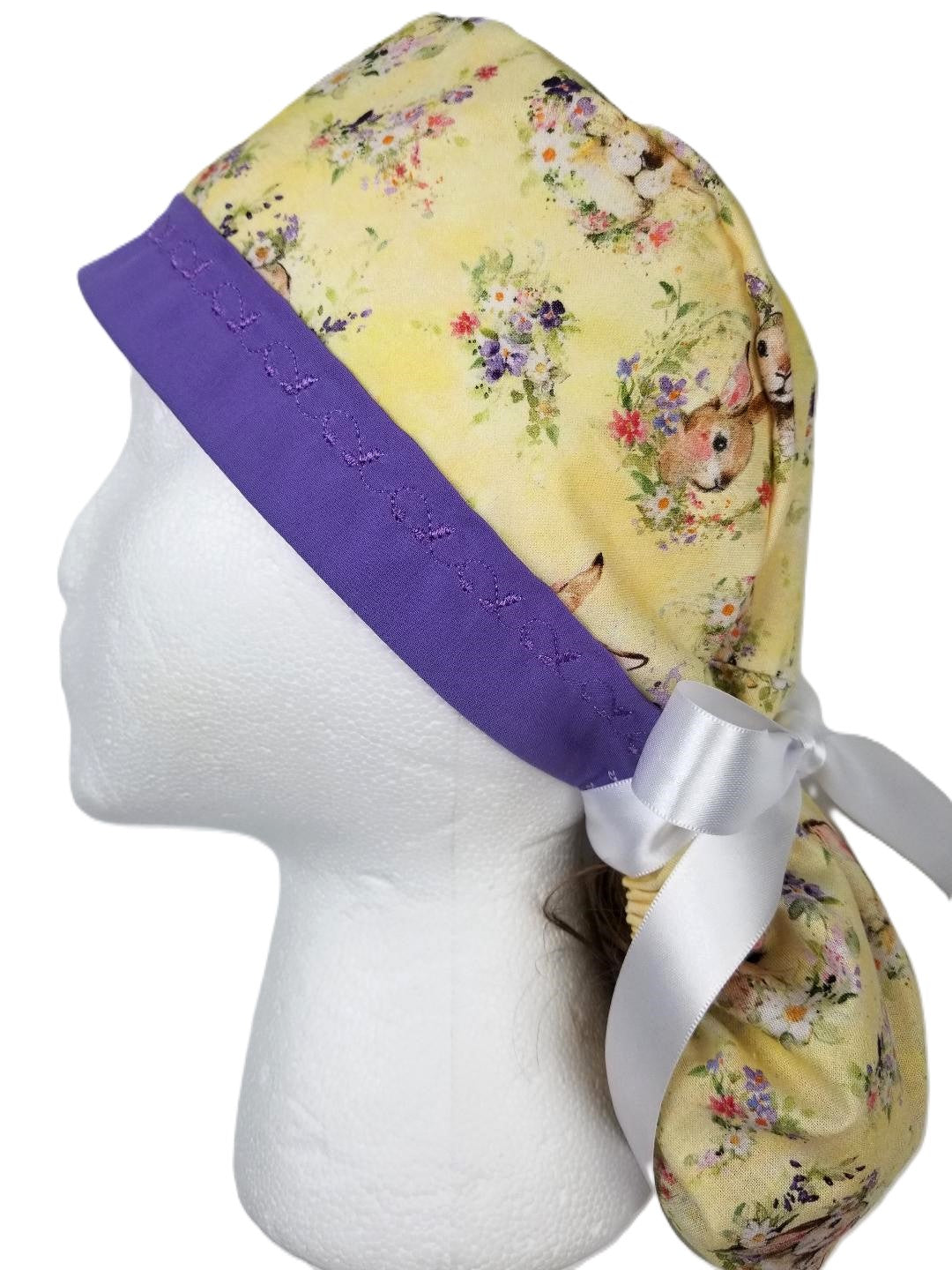 Yellow vintage bunny print ponytail surgical cap with a purple designer-stitched headband by Coastline Boutique