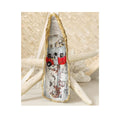 A handcrafted gilded oyster shell ornament featuring a vintage red and silver camper birdhouse design, staged on a coastal background of white coral and a starfish