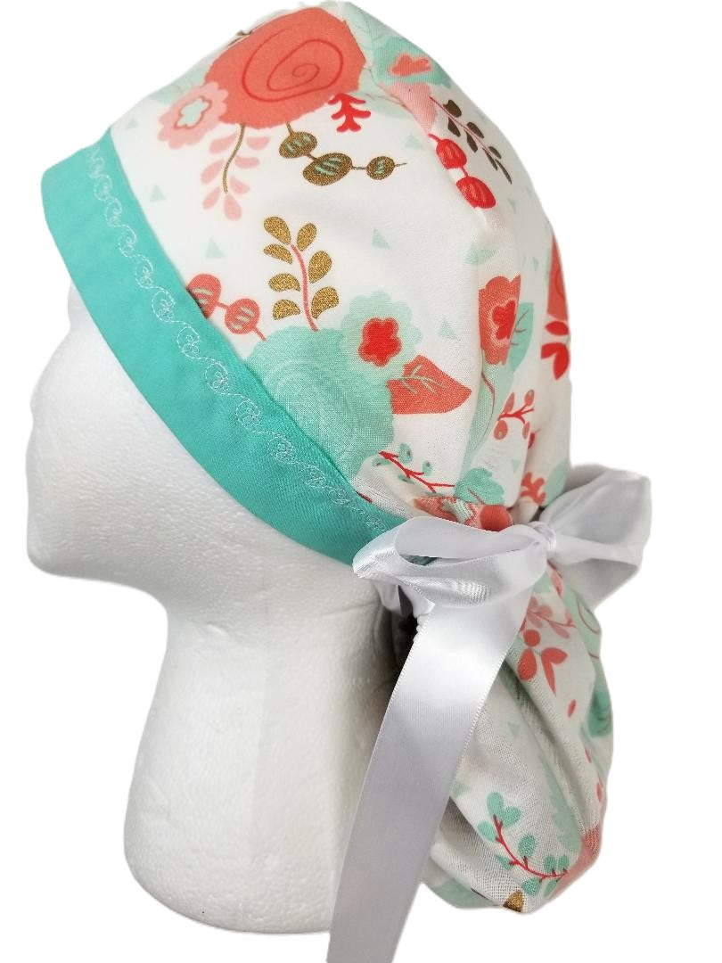 Soft mint mango and peach floral surgical cap with gold accents and a designer-stitched headband by Coastline Boutique