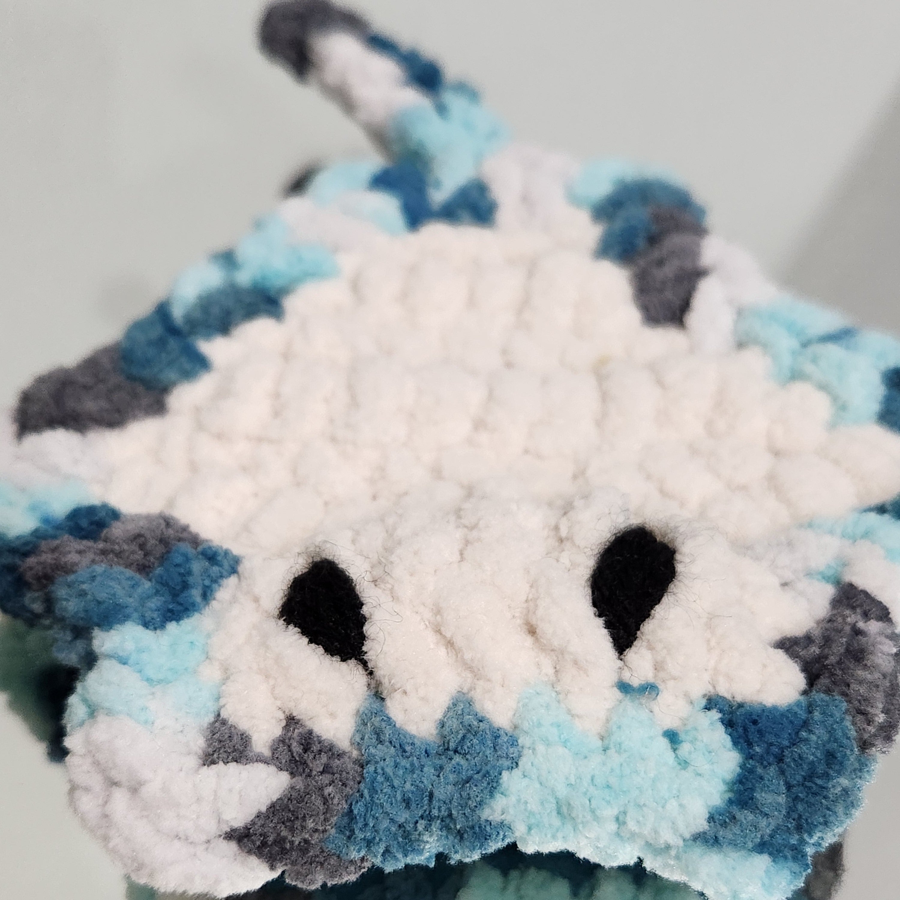 Close-up of the baby stingray "Sol" from the signature Brejoy set, highlighting the delicate hand-stitched crochet details and soulful embroidered eyes, by Coastline Boutique